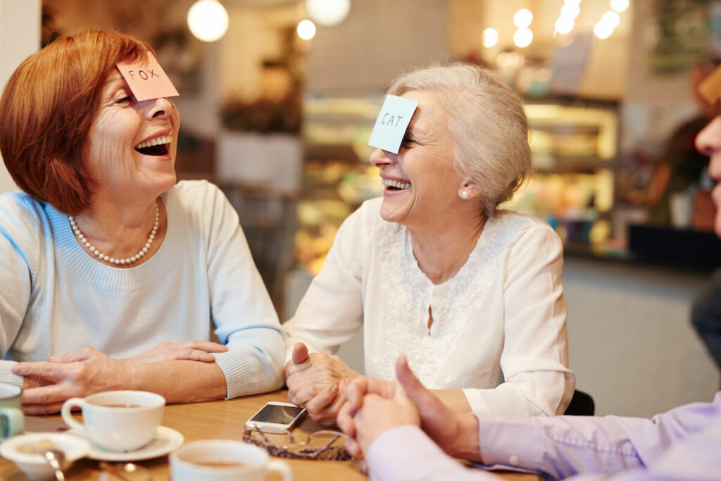 Broadway Mesa Village | A group of seniors laughing and having fun playing games