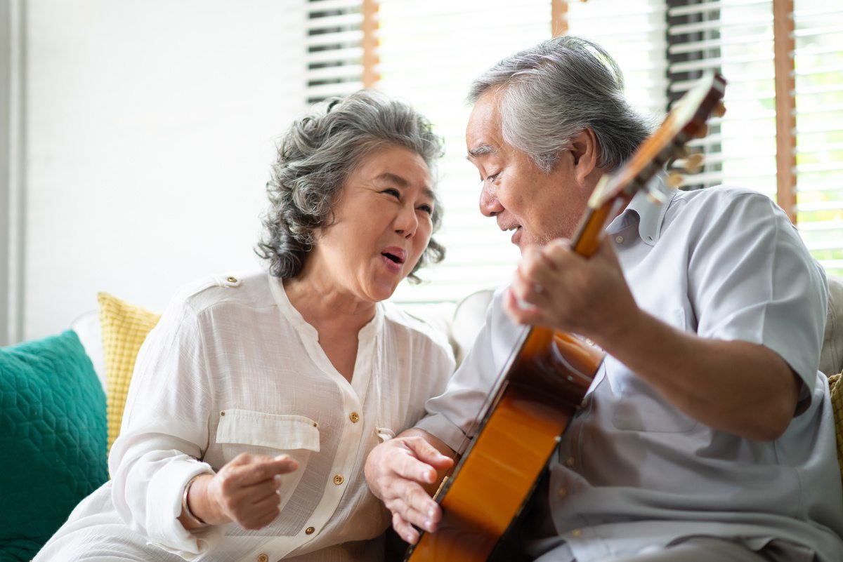 Broadway Mesa Village | Senior couple playing the guitar and singing